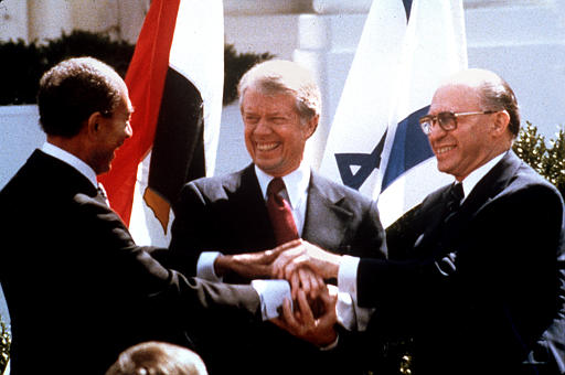 Anwar Sadat, Jimmy Carter and Menachem Begin, on signing Israeli-Egyptian Peace Treaty, North lawn of the White House, March 26, 1979.